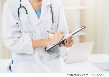 Young female doctor working in hospital office. Young female doctor working in hospital office. 47065562