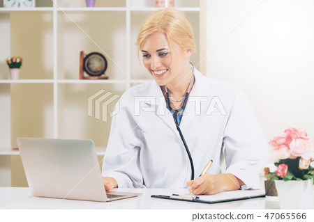 Young female doctor working in hospital office. Young female doctor working in hospital office. 47065566