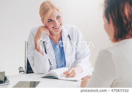 Woman Doctor and Female Patient in Hospital Office 47065592