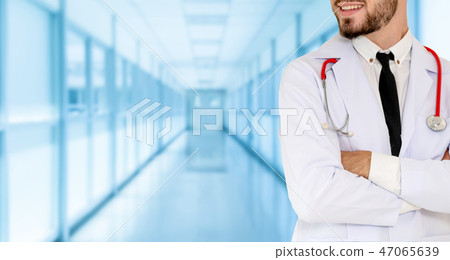Young male doctor working at the hospital. Young male doctor working at the hospital. 47065639