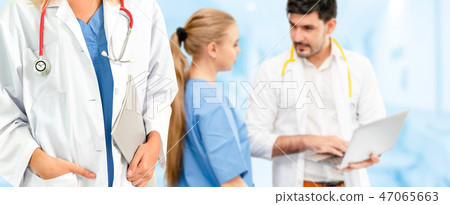 Doctor working in hospital with other doctors. 47065663