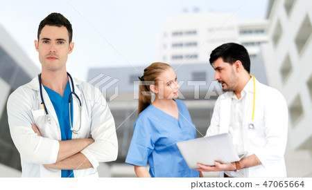 Doctor working in hospital with other doctors. Doctor working in hospital with other doctors. 47065664
