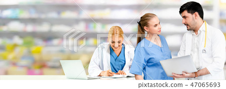 Doctor working in hospital with other doctors. 47065693