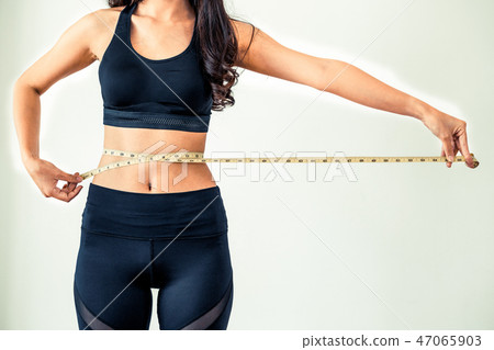 Close up shot woman with slim body measuring torso 47065903