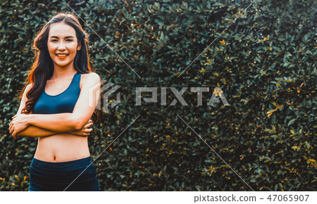 Young sport woman doing morning exercise in park. Young sport woman doing morning exercise in park. 47065907