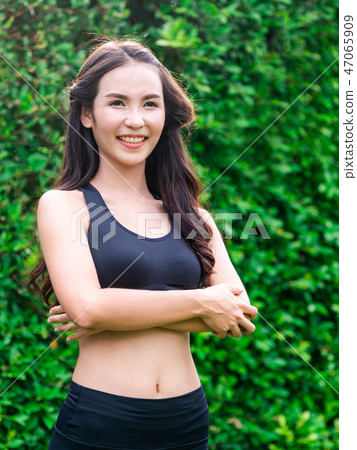 Young sport woman doing morning exercise in park. Young sport woman doing morning exercise in park. 47065909
