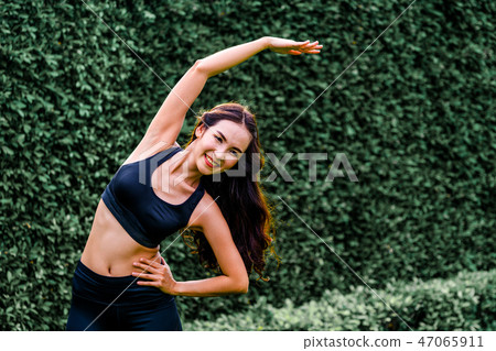 Young sport woman doing morning exercise in park. Young sport woman doing morning exercise in park. 47065911