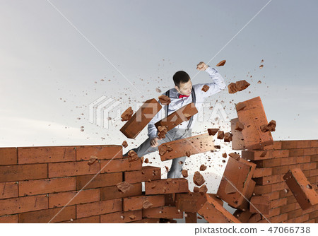Businessman crashing bricks Businessman crashing bricks 47066738