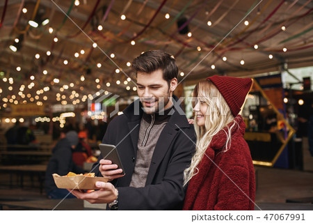 Couple taking pictures of mexican food. The concept of Mexican cuisine. Couple taking pictures of mexican food. The concept of Mexican cuisine. 47067991