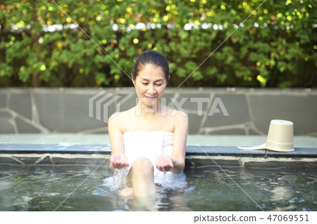 Woman bathing in a bath Woman bathing in a bath 47069551