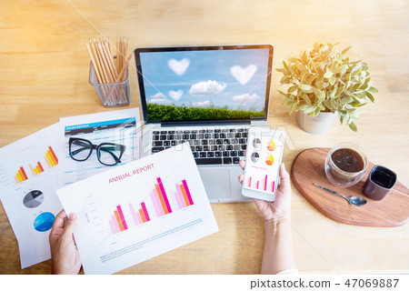 Beautiful business working woman using Iphone Ipad 47069887