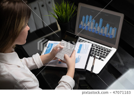 Businesswoman investment consultant analyzing company annual financial report balance sheet 47071183