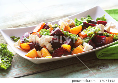 Fresh beet salad with feta cheese and fried cabbage kale 47071458