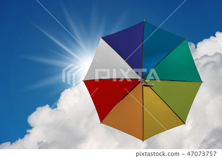 Multicolor umbrella flying in the sky Multicolor umbrella flying in the sky 47073757