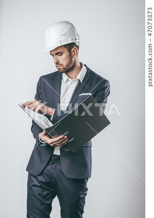 Engineer turning pages in folder Engineer turning pages in folder 47073873