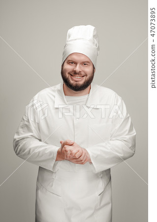 Cheerful cook clasping hands 47073895