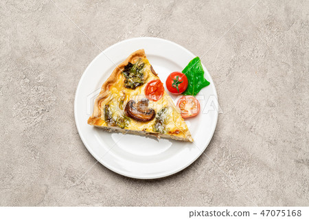 Slice of traditonal homemade spinach chicken quiche tart or pie on plate 47075168