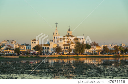 El Rocio church and crowded streets with many tourists at dusk 47075356