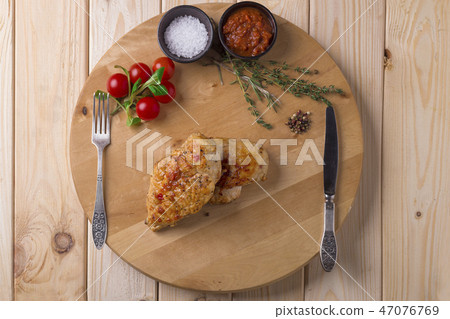 grilled chicken fillets on wooden cutting board, top view grilled chicken fillets on wooden cutting board, top view 47076769