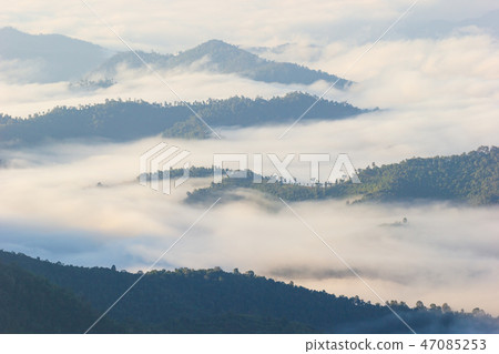 fog moves along the mountains in the morning. 47085253