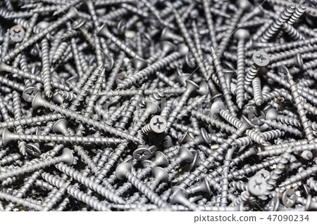 focus on center. black screws texture background 47090234