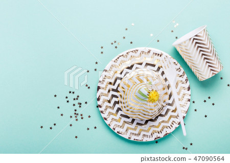 Party Turquoise background with paper gold dishes 47090564