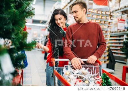 Couple buying christmas tree in supermarket 47090646