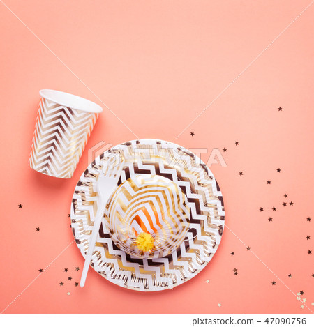 Golden striped dishes on a coral background. Part 47090756