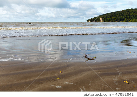 Abandoned beach with branch on sand and sea water 47091041