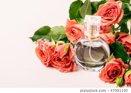 bottle of perfume on the background of a bouquet  47091195