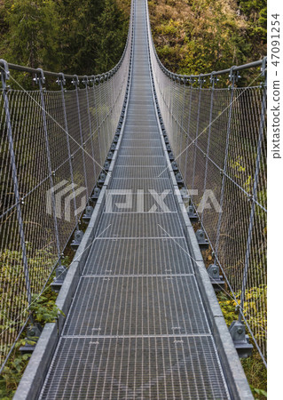 suspended bridge on alps 47091254