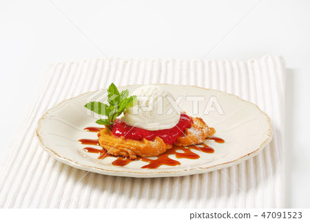 Spritz cookie with raspberry sauce and ice cream 47091523