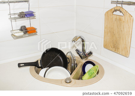 huge heap of dirty dishes waiting for the flatmate huge heap of dirty dishes waiting for the flatmate 47092659