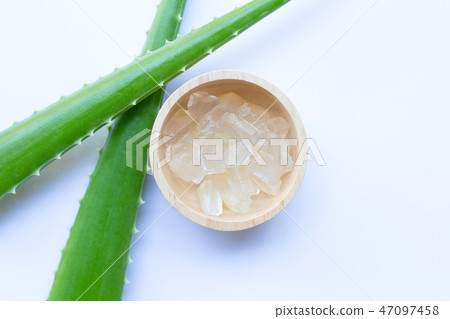 Aloe vera gel in wooden bowl on white 47097458