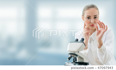 Scientist researcher uses microscope in laboratory 47097943