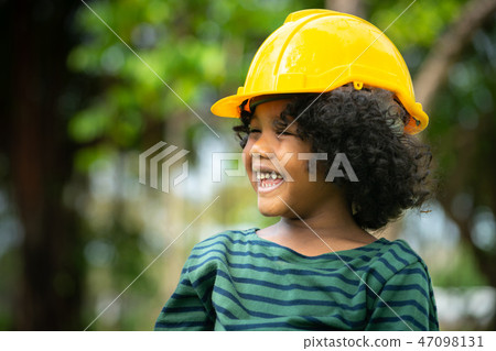 Happy little boy engineer wearing helmet hard hat. Happy little boy engineer wearing helmet hard hat. 47098131