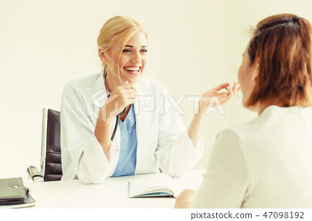 Woman Doctor and Female Patient in Hospital Office 47098192