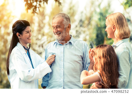 Happy healthy family and doctor talking in park. Happy healthy family and doctor talking in park. 47098252