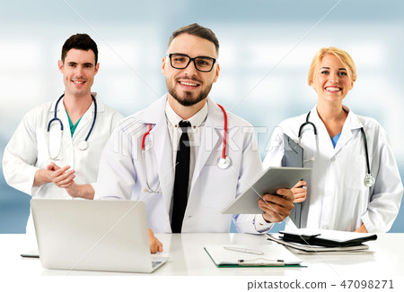 Doctor working in hospital with other doctors. 47098271