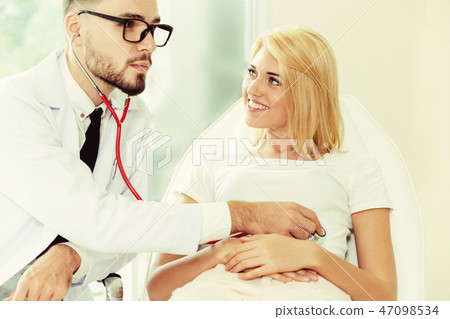 Male Doctor and Female Patient in Hospital Office Male Doctor and Female Patient in Hospital Office 47098534