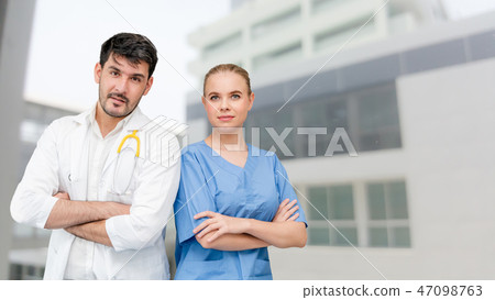 Doctors at hospital working with another doctor. Doctors at hospital working with another doctor. 47098763