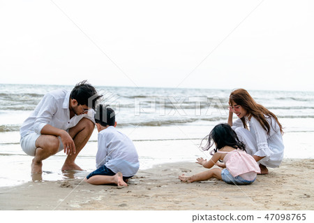 Happy family goes vacation on the beach in summer. 47098765