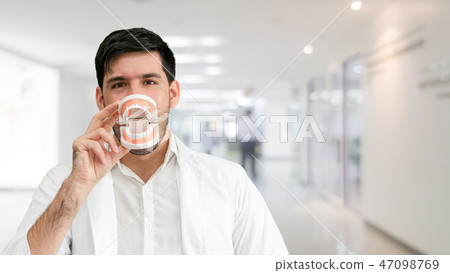 Young male dentist working in dental clinic. Young male dentist working in dental clinic. 47098769