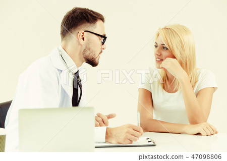 Male Doctor and Female Patient in Hospital Office Male Doctor and Female Patient in Hospital Office 47098806