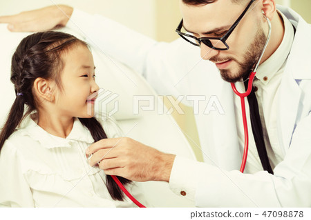 Doctor examining little happy kid in hospital. 47098878