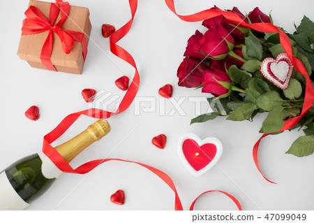 close up of champagne, gift, candies and red roses 47099049