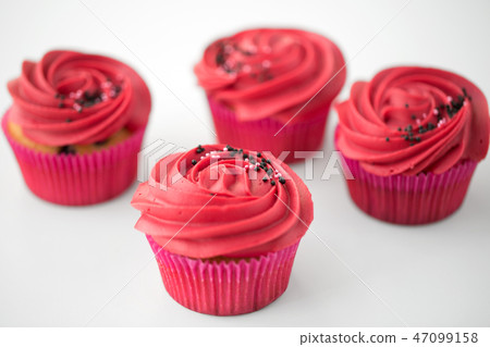 close up of cupcakes with red buttercream frosting close up of cupcakes with red buttercream frosting 47099158
