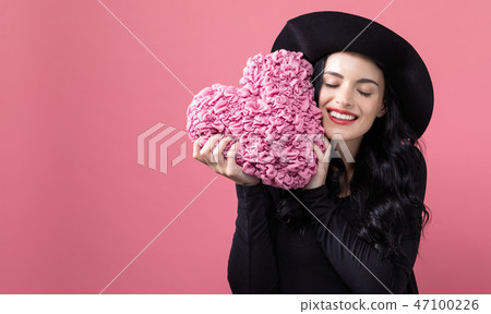 Woman holding a heart cushion in Valentine's day theme 47100226
