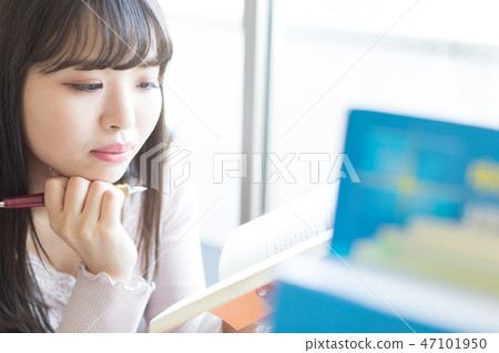 A woman studying A woman studying 47101950