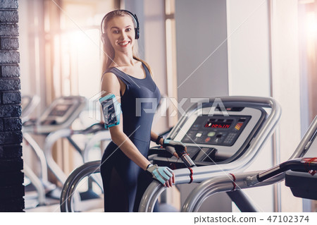 Happy women jogging on a treadmill for health. 47102374